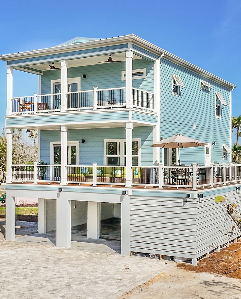 ArmCoa-built two-story home with spacious balconies and light blue siding—designed for comfort, ROI, and durability.