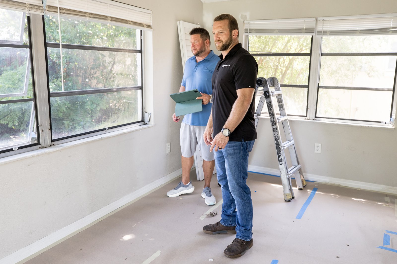 Two ARMCOA team members assessing a residential interior during recovery work